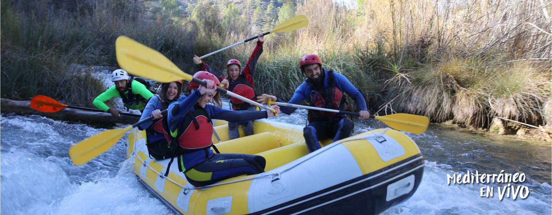 Four young people rafting in Venta del Moro